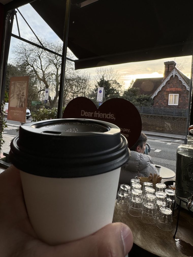 Takeaway coffee in a lidded cup by the window