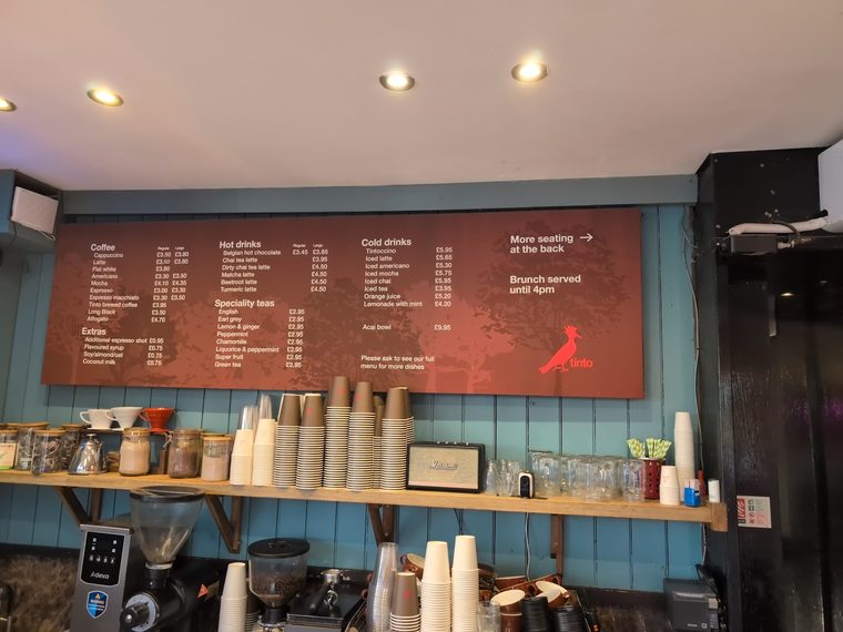 The back bar with cup stacks, grinder and jars on the shelf