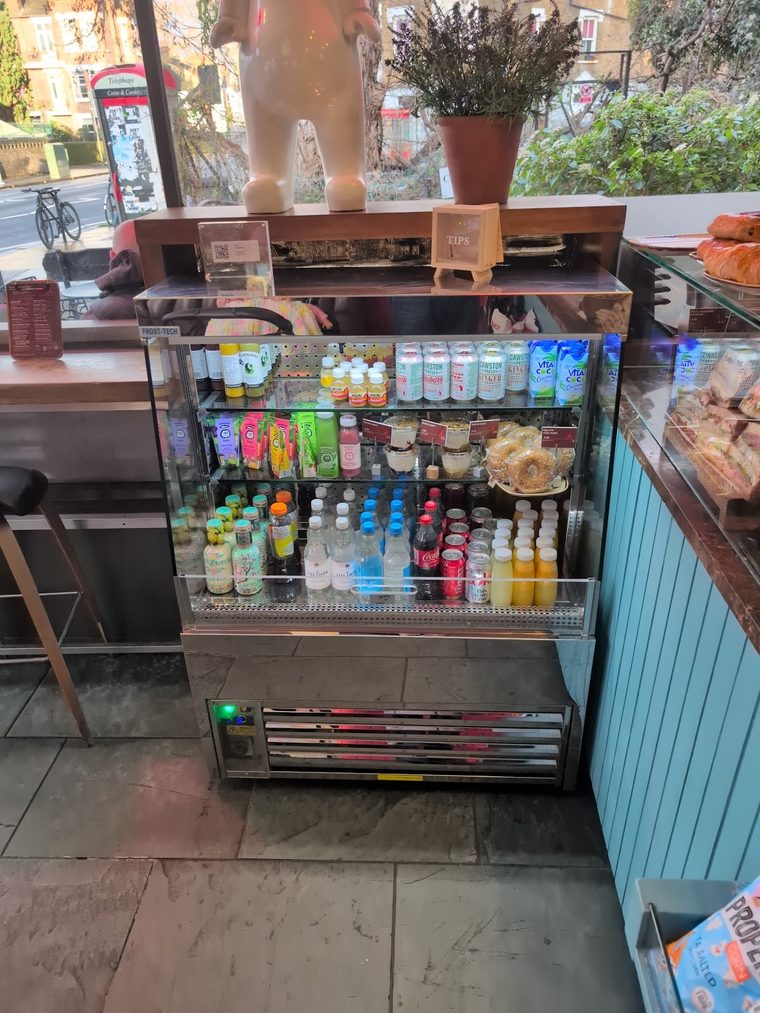 Chilled drinks fridge and grab-and-go shelving by the window